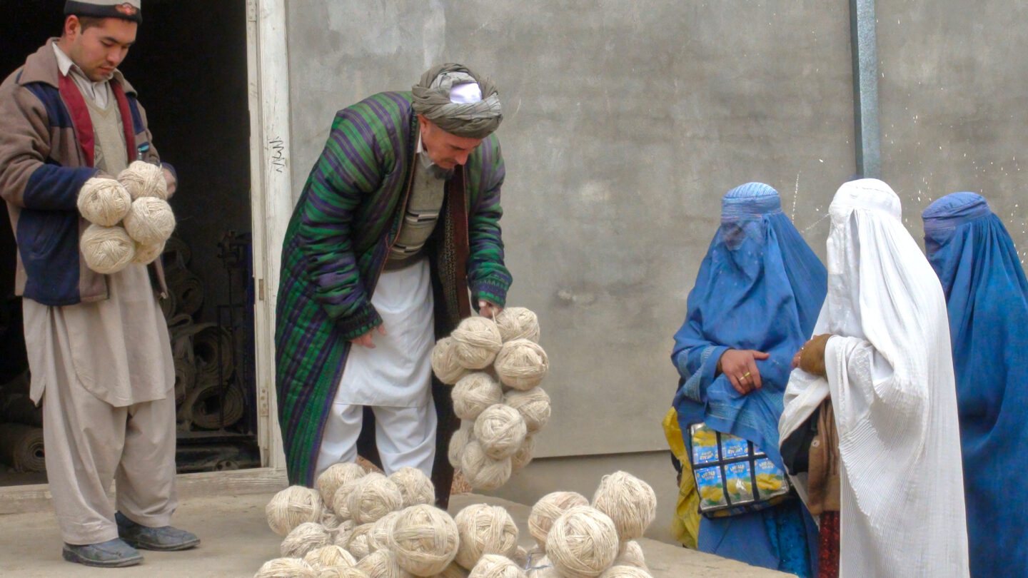 Afghan weavers collect yarn at the bazaar